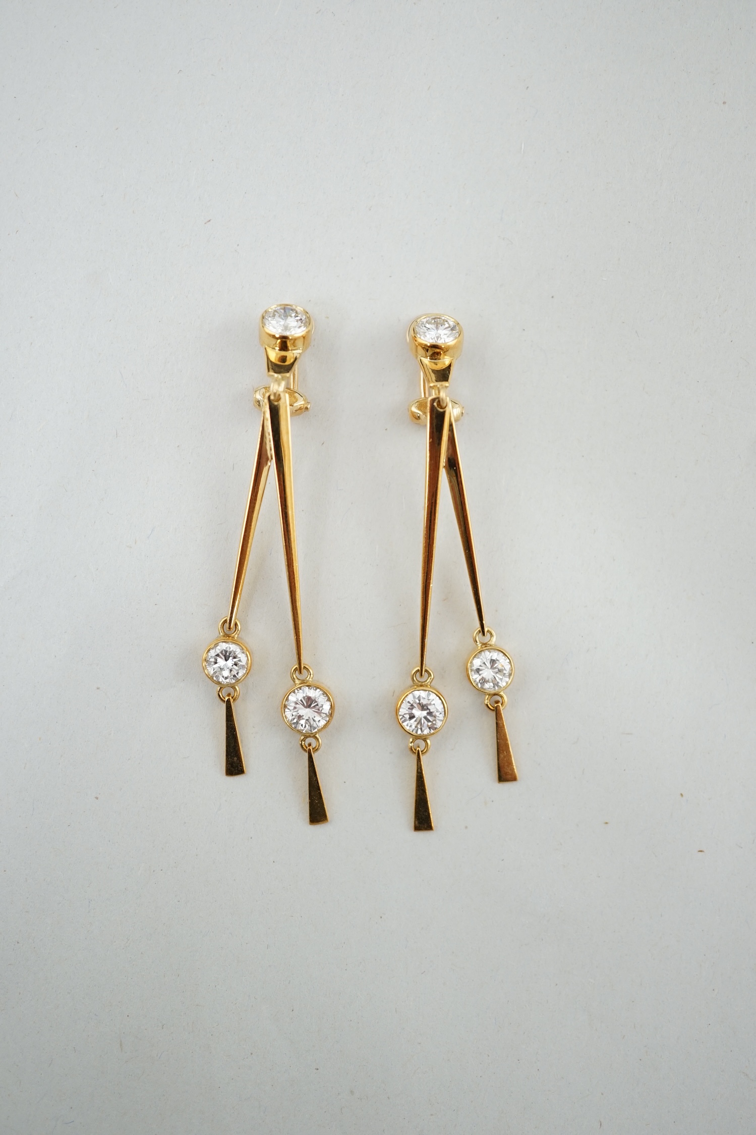 A pair of modern 18ct gold and three stone diamond set double drop ear clips